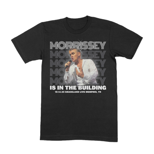 Black t-shirt with text 'MORRISSEY IS IN THE BUILDING' and event details printed on the front.