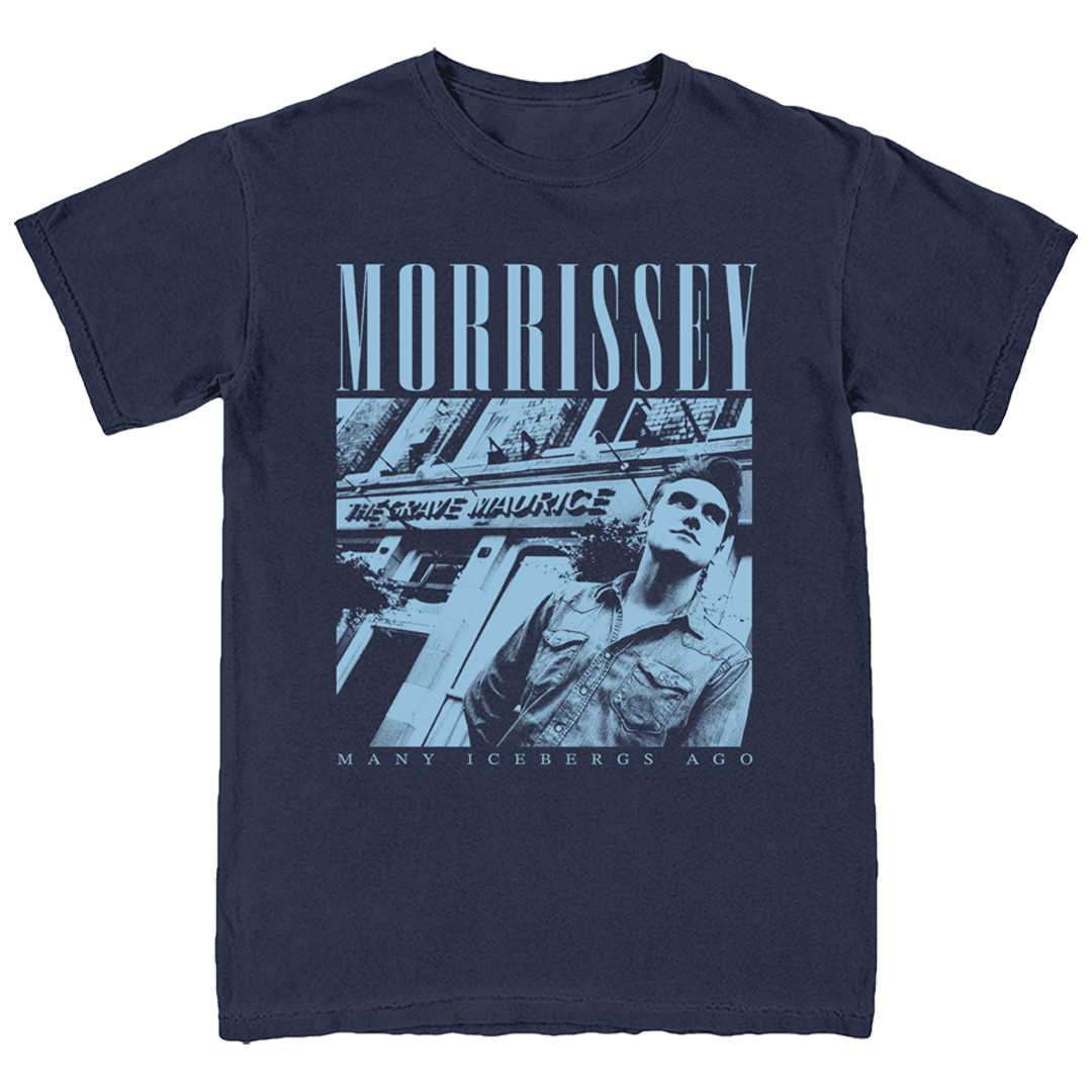 A navy blue short-sleeve graphic t-shirt featuring a monochrome blue-toned print of Morrissey with the text 'MORRISSEY' and 'MANY ICEBERGS AGO' on a white background.