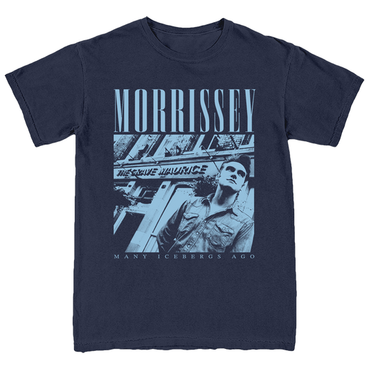A navy blue short-sleeve graphic t-shirt featuring a monochrome blue-toned print of Morrissey with the text 'MORRISSEY' and 'MANY ICEBERGS AGO' on a white background.